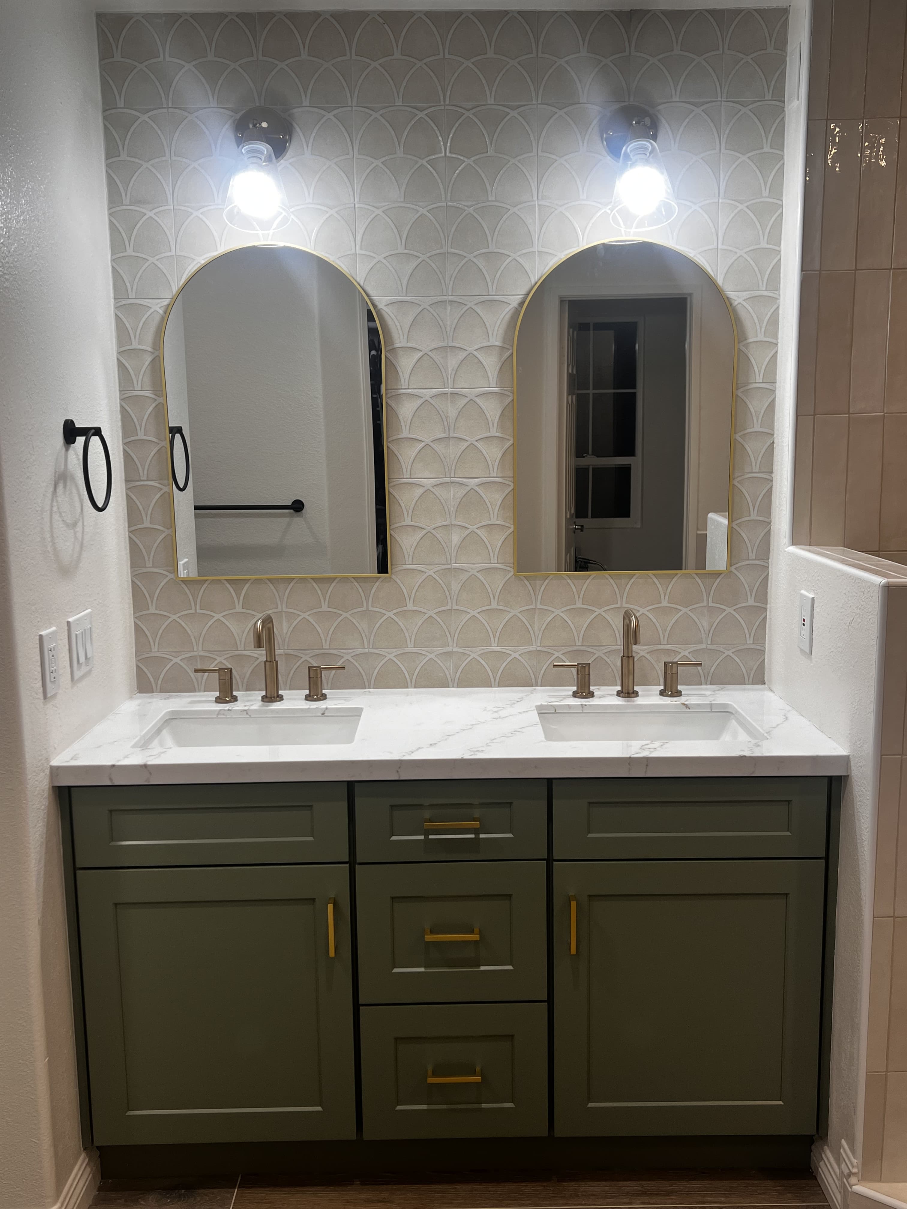 Double sink bathroom vanity with gold fixtures